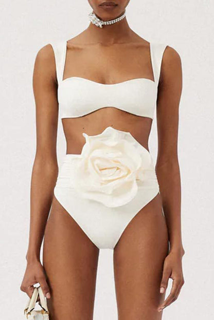 Woman in ivory textured high-waisted swimsuit with large floral detail