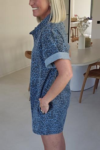 Woman wearing a blue leopard print denim romper.
