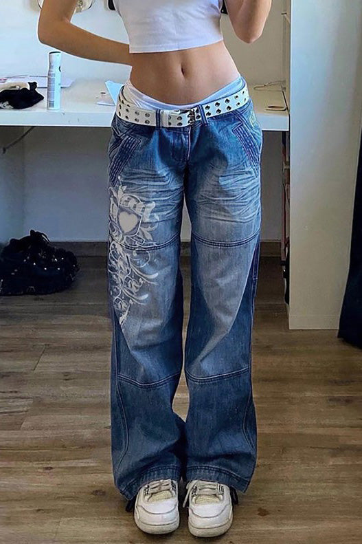 Woman wearing wide leg blue denim jeans with white graphic design