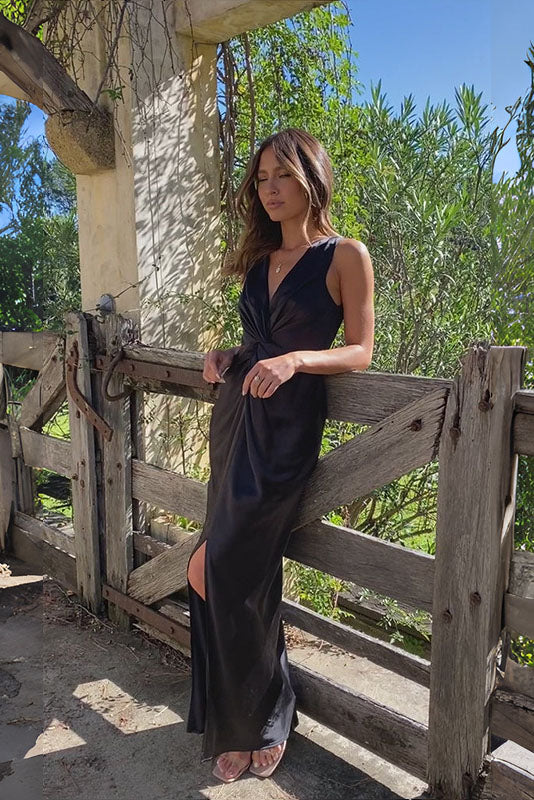 Woman in rust satin maxi dress with twisted bodice