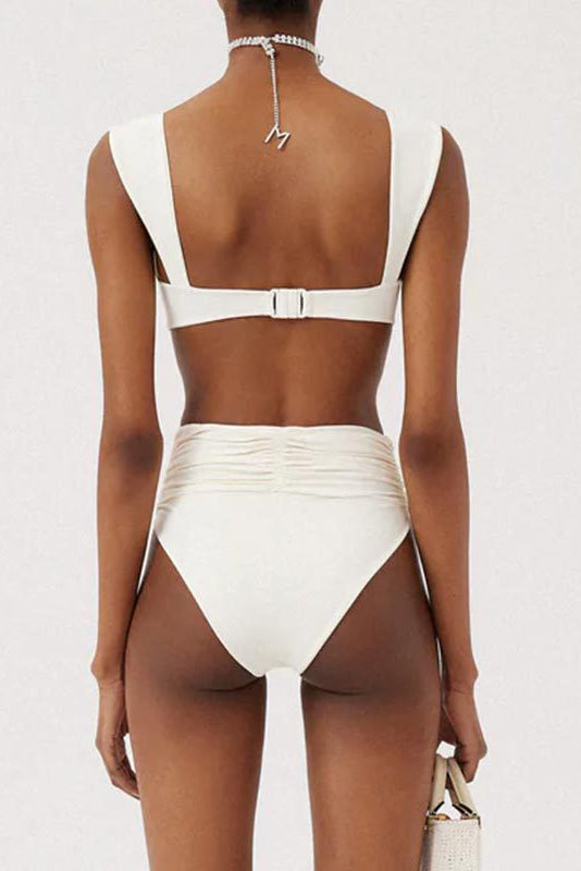 Woman in ivory textured high-waisted swimsuit with large floral detail