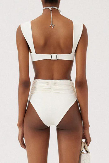 Woman in ivory textured high-waisted swimsuit with large floral detail