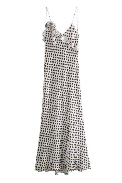 Woman in white satin polka dot dress with ruffle detail