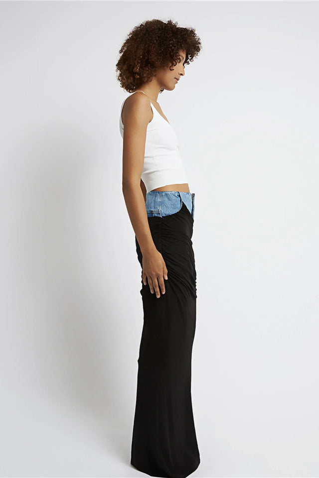 Woman wearing white ribbed tank top and denim/black jersey maxi skirt
