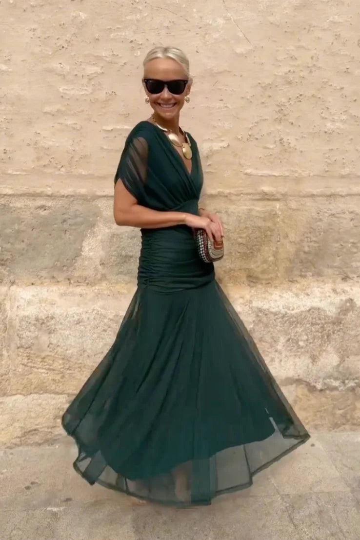 Woman in floral chiffon off-the-shoulder maxi dress