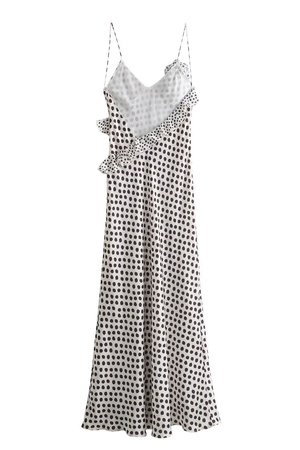 Woman in white satin polka dot dress with ruffle detail