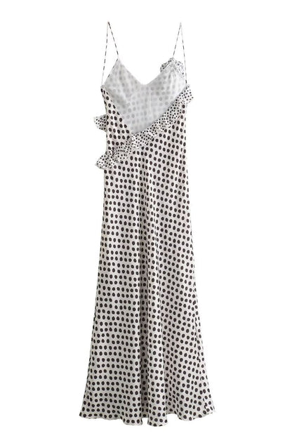 Woman in white satin polka dot dress with ruffle detail
