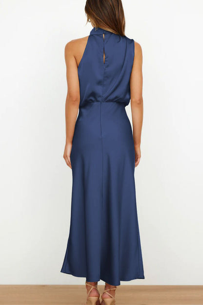 Woman in navy blue satin halter midi dress