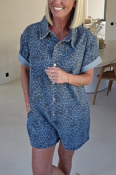Woman wearing a blue leopard print denim romper.