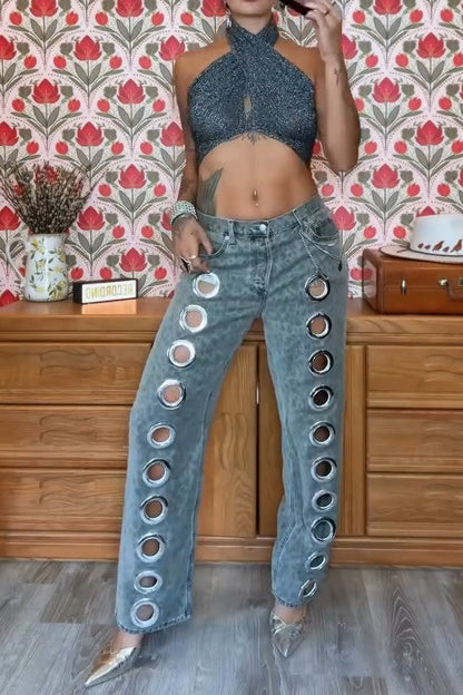 Woman wearing gray acid wash jeans with grommets