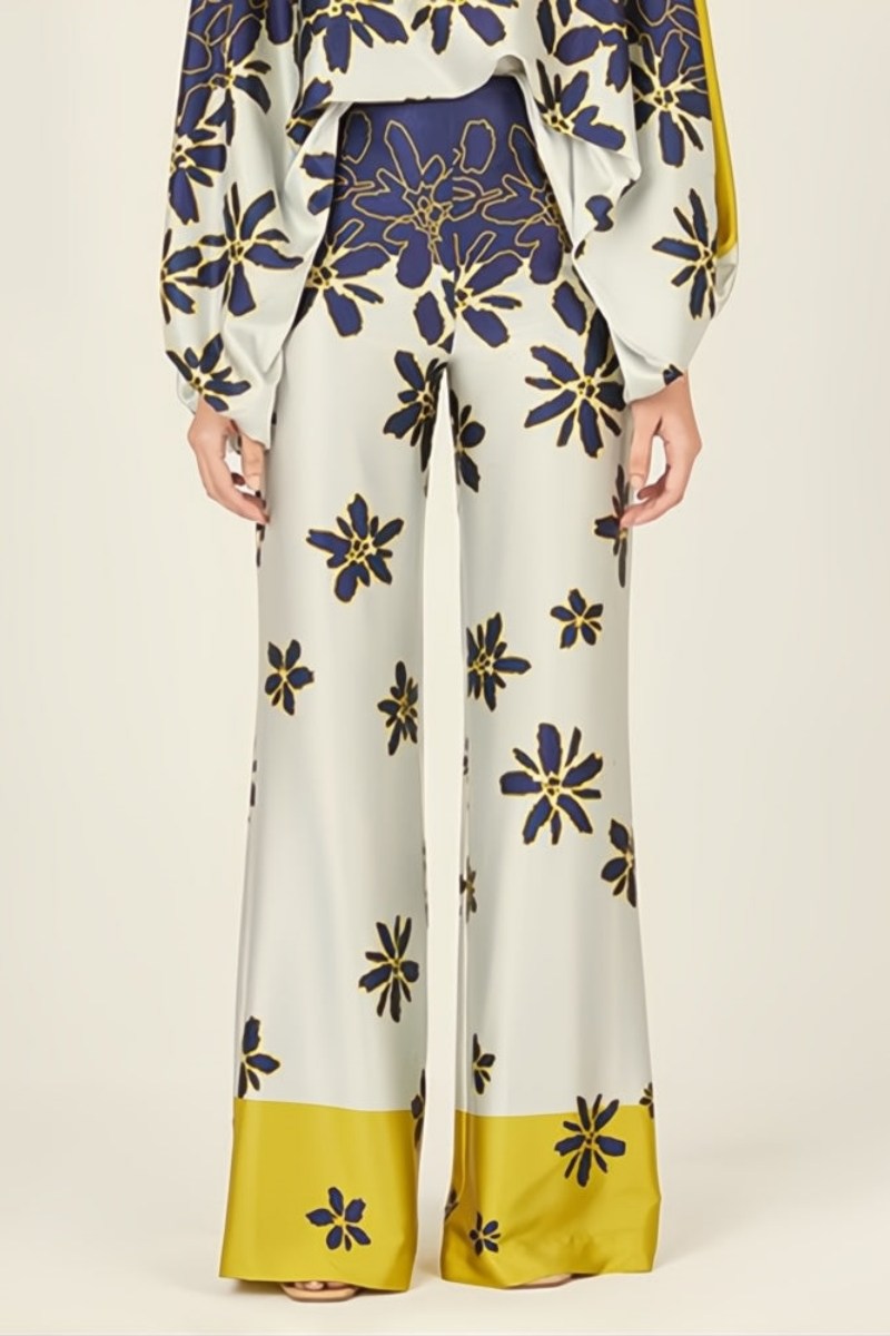 Woman wearing a blue and yellow silk floral print two-piece set.