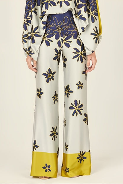 Woman wearing a blue and yellow silk floral print two-piece set.