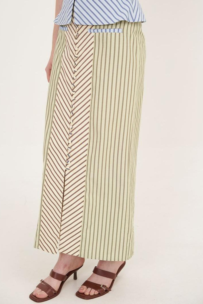 Woman in striped halter top and maxi skirt set