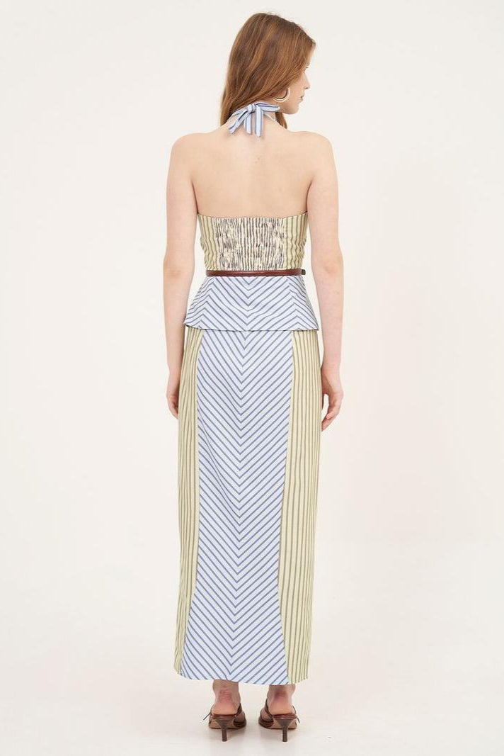 Woman in striped halter top and maxi skirt set