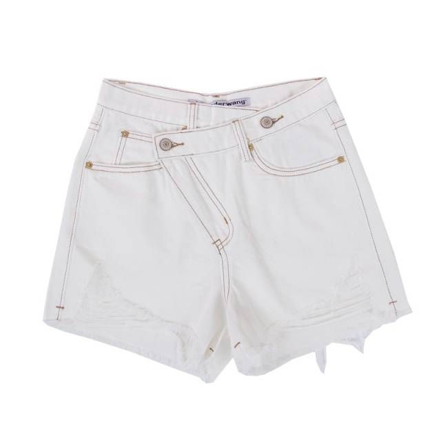 Woman wearing light wash denim shorts with asymmetrical waist and distressed hem.