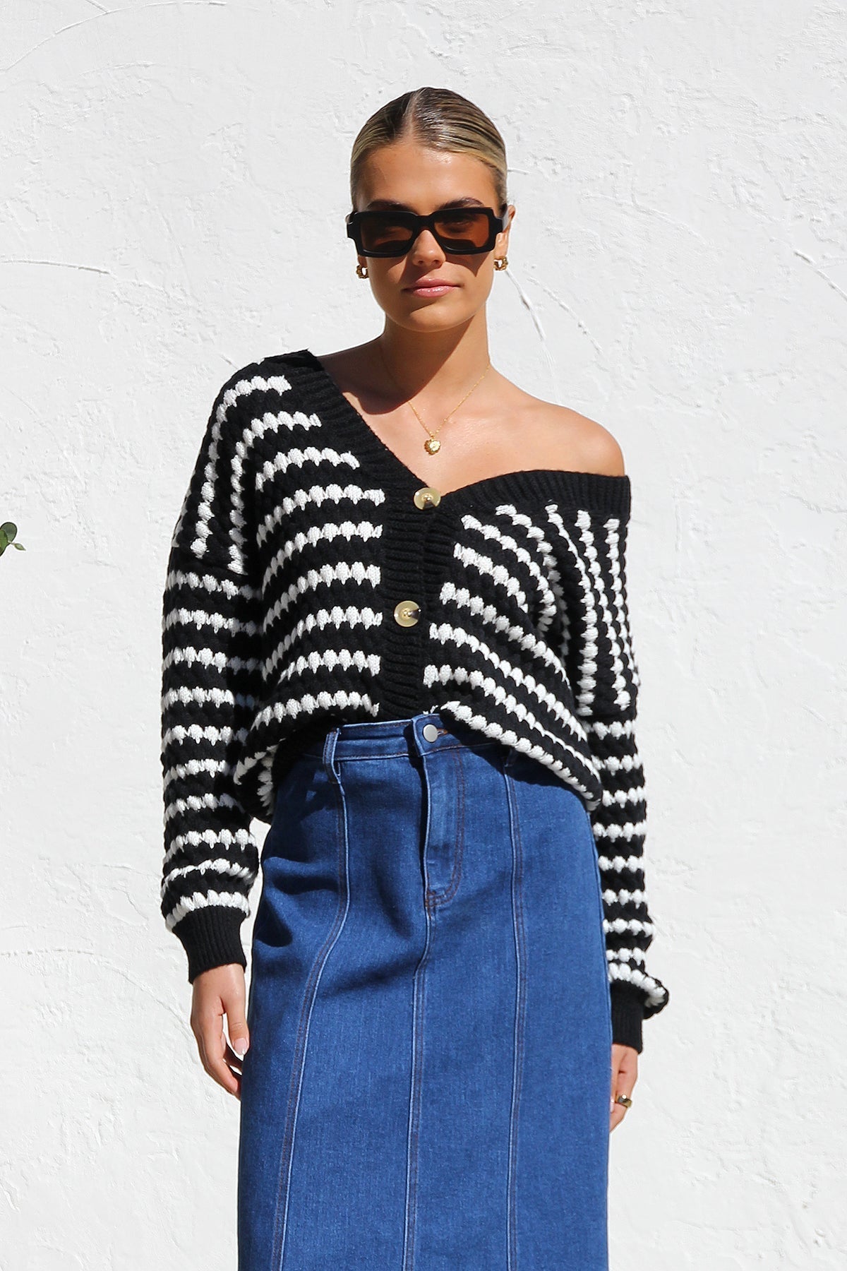 Woman wearing a blue denim maxi skirt with panelled design