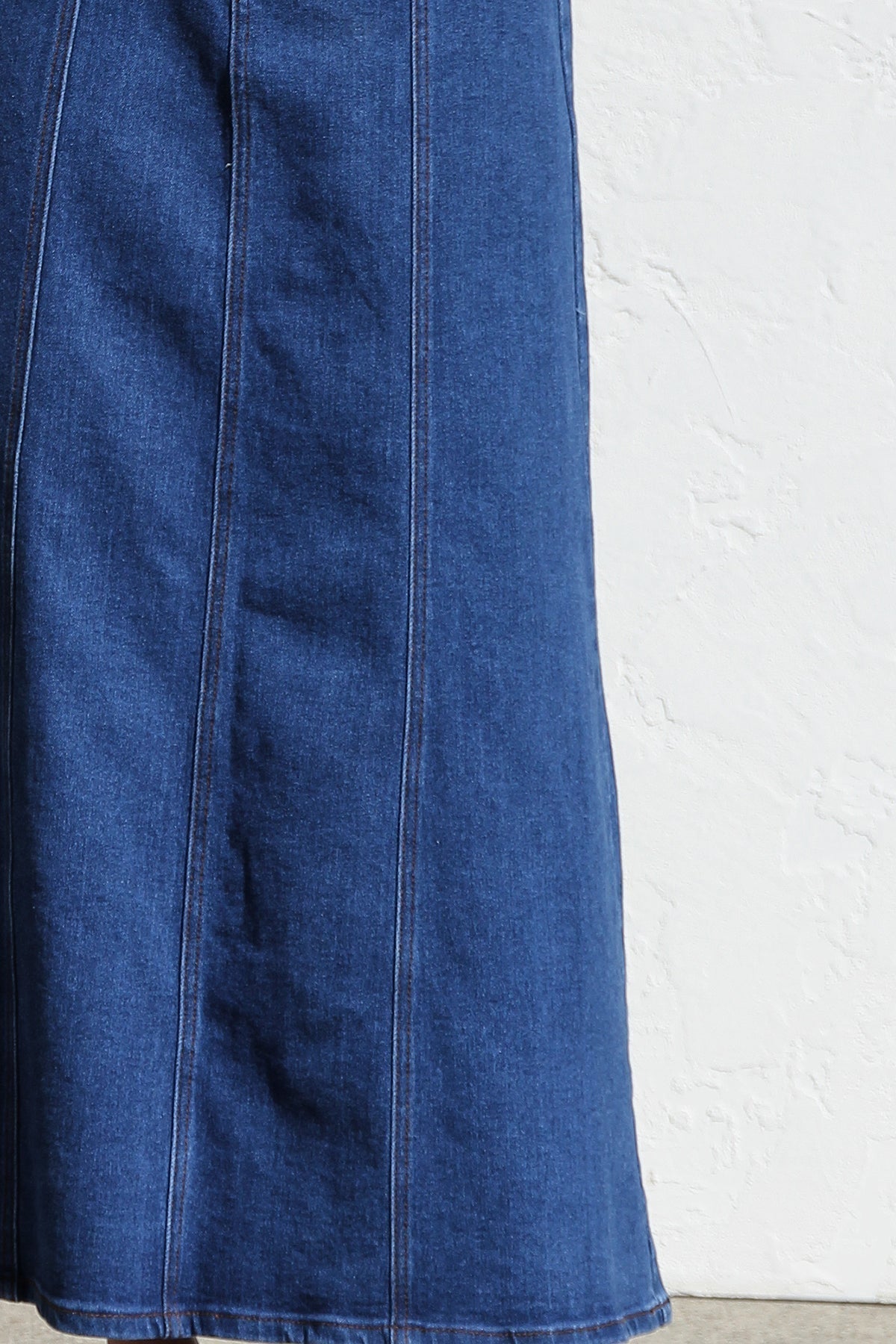 Woman wearing a blue denim maxi skirt with panelled design