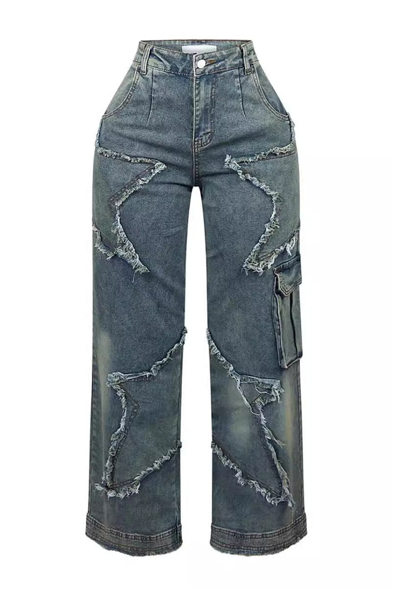 Woman wearing brown sheer corset top and distressed star-detail jeans