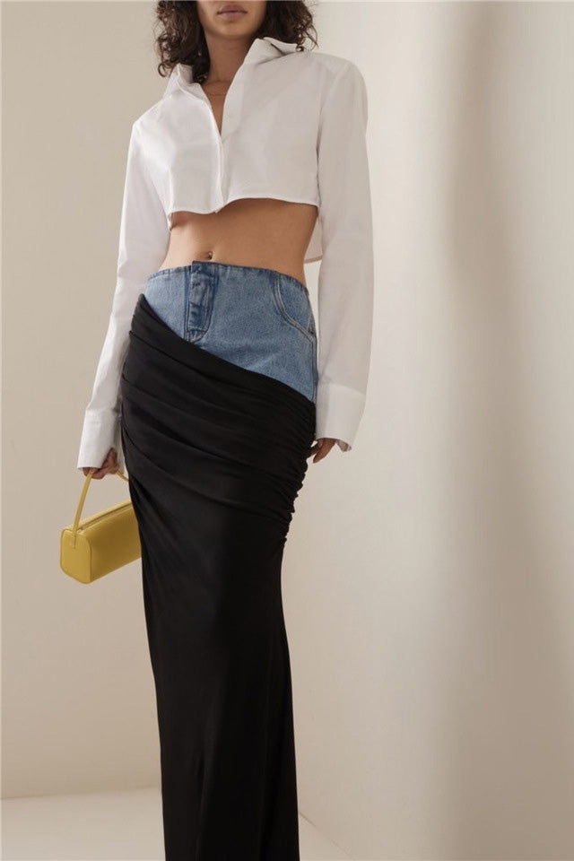 Woman wearing white ribbed tank top and denim/black jersey maxi skirt