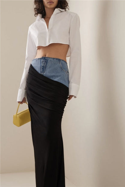 Woman wearing white ribbed tank top and denim/black jersey maxi skirt