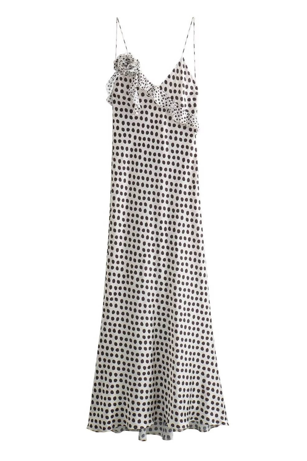 Woman in white satin polka dot dress with ruffle detail