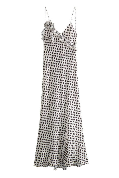 Woman in white satin polka dot dress with ruffle detail