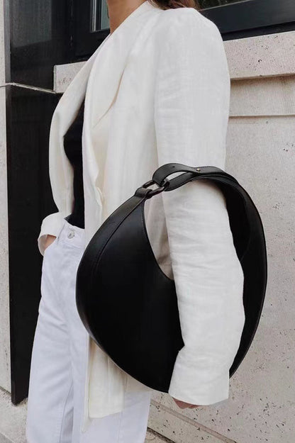 Tan leather crescent-shaped shoulder bag with top handle