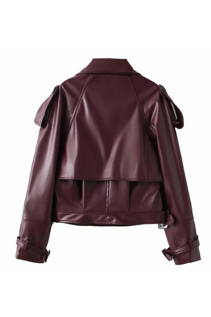 Woman in burgundy faux leather oversized jacket with matching headband and purse