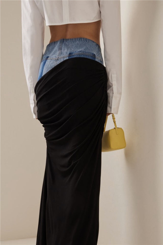 Woman wearing white ribbed tank top and denim/black jersey maxi skirt