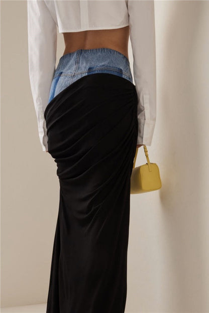 Woman wearing white ribbed tank top and denim/black jersey maxi skirt