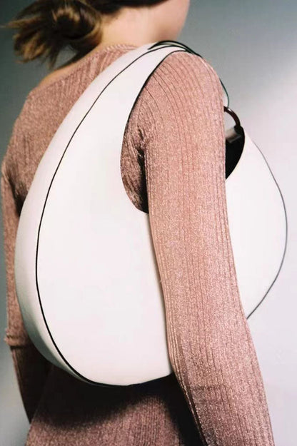 Tan leather crescent-shaped shoulder bag with top handle