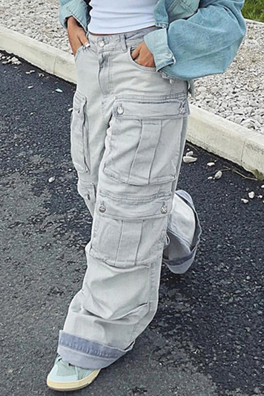 Light wash denim cargo pants with wide legs and multiple pockets.