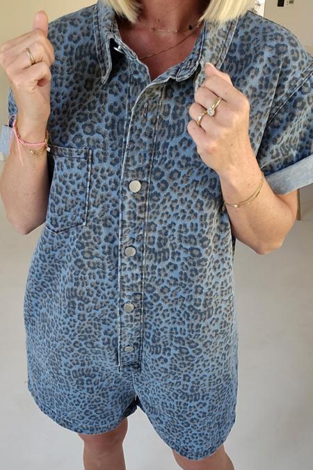Woman wearing a blue leopard print denim romper.