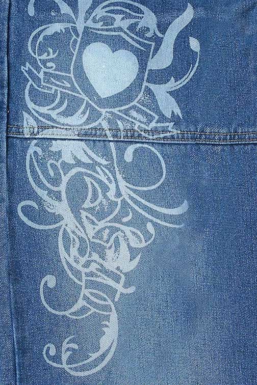 Woman wearing wide leg blue denim jeans with white graphic design