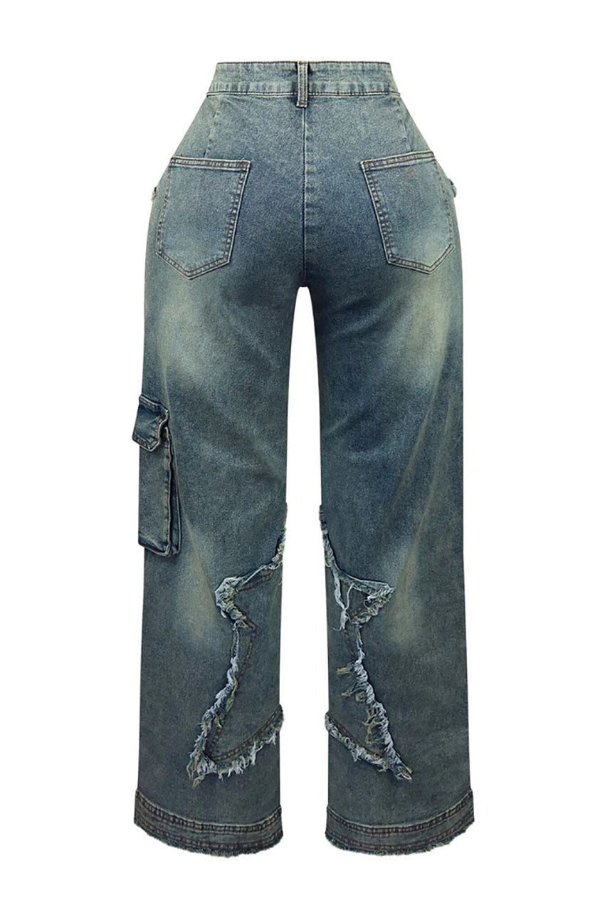 Woman wearing brown sheer corset top and distressed star-detail jeans