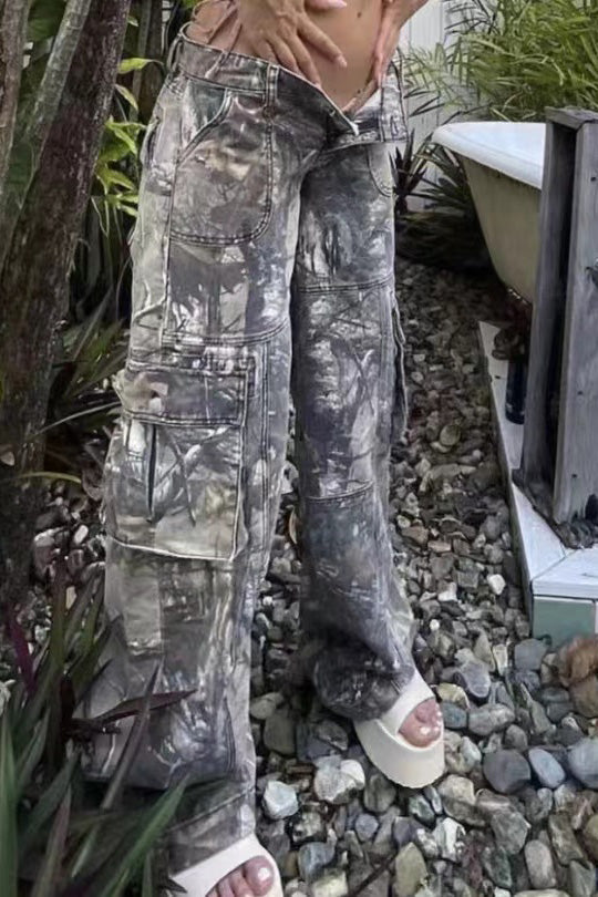 Camouflage print cargo pants with wide legs and low rise.