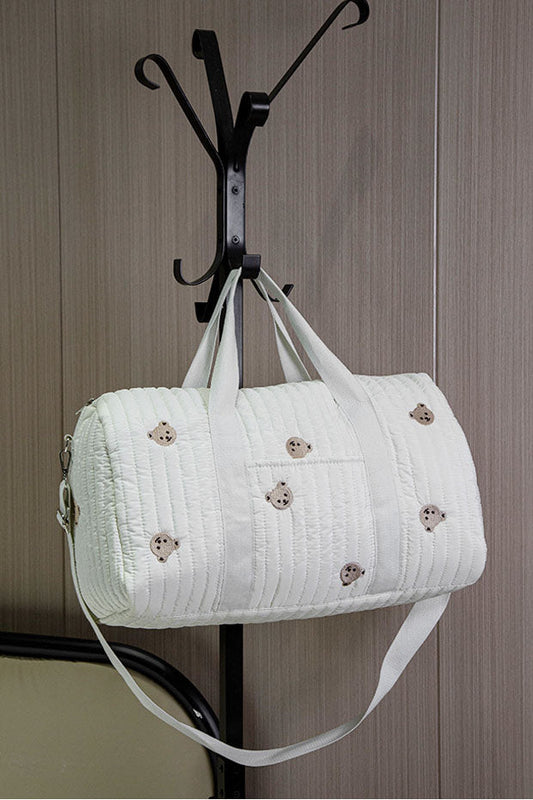 Off-white quilted barrel bag with bear embroidery hanging on coat rack