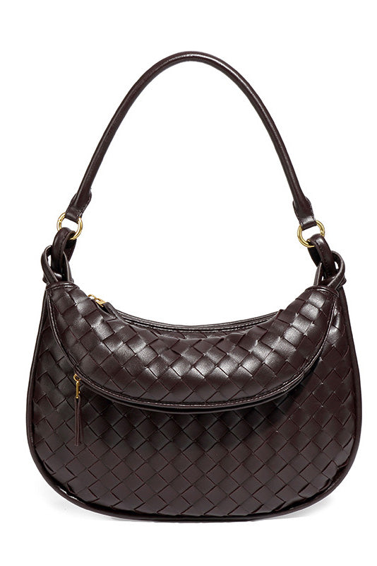 Woman holding dark brown woven leather hobo bag