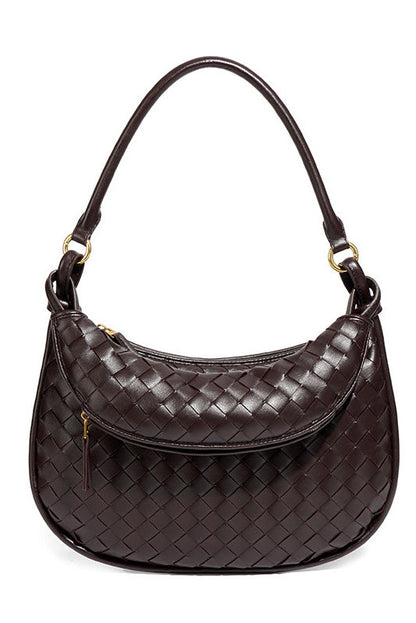 Woman holding dark brown woven leather hobo bag