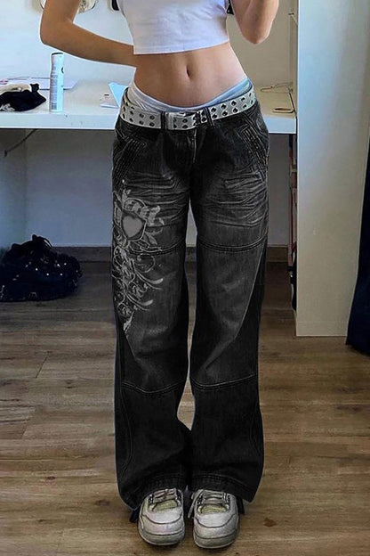 Woman wearing wide leg blue denim jeans with white graphic design