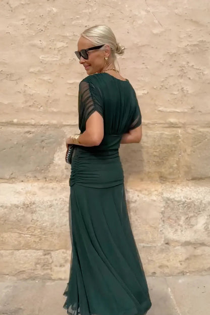Woman in floral chiffon off-the-shoulder maxi dress