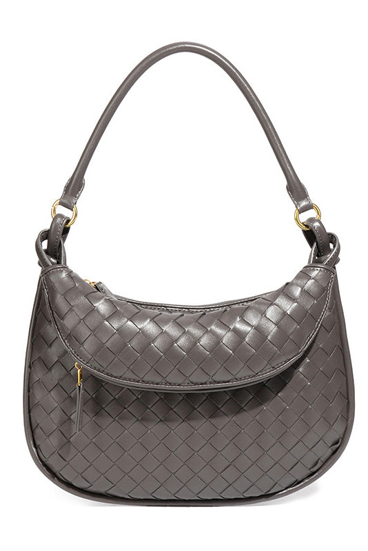 Woman holding dark brown woven leather hobo bag