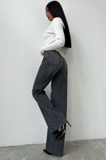 Woman in gray leopard print wide leg jeans and white ribbed knit top