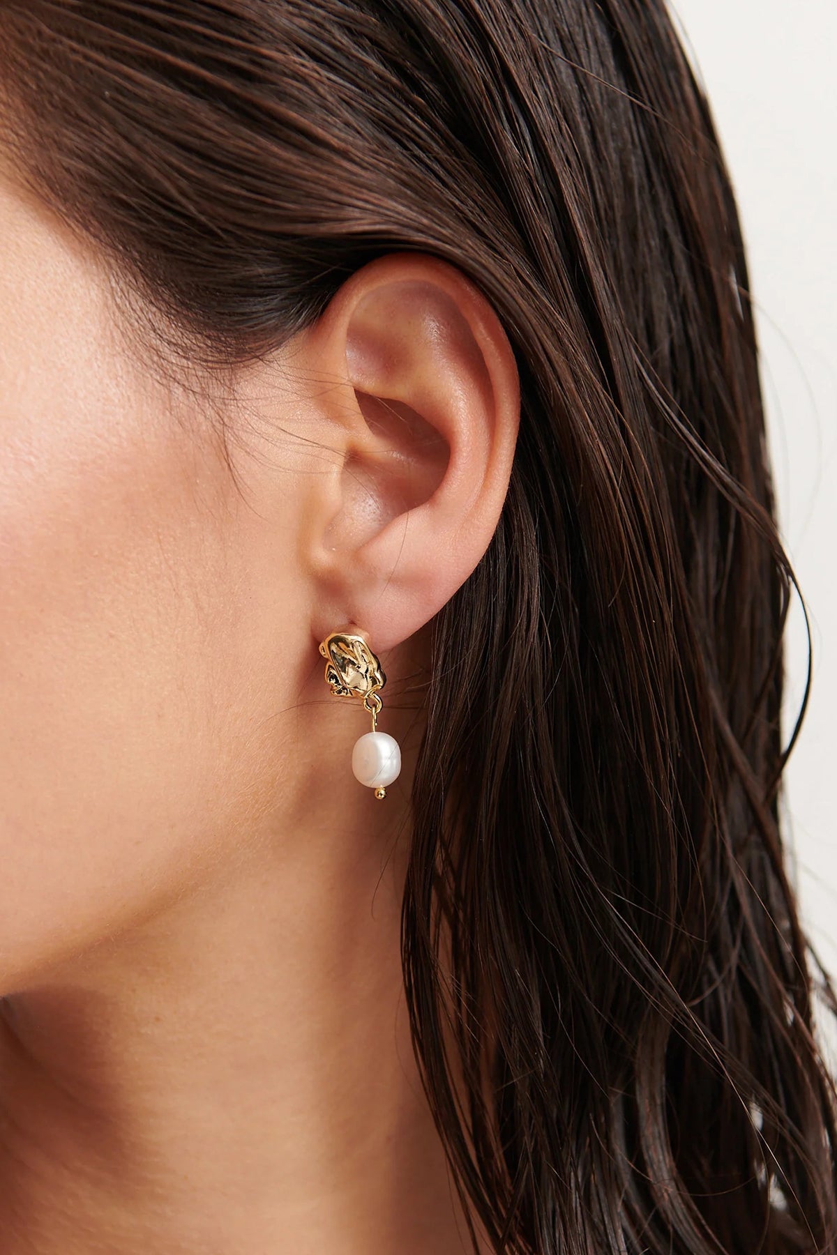 Close up of gold vermeil drop earrings with pearl