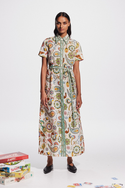 Woman in ivory paisley linen maxi dress with belt