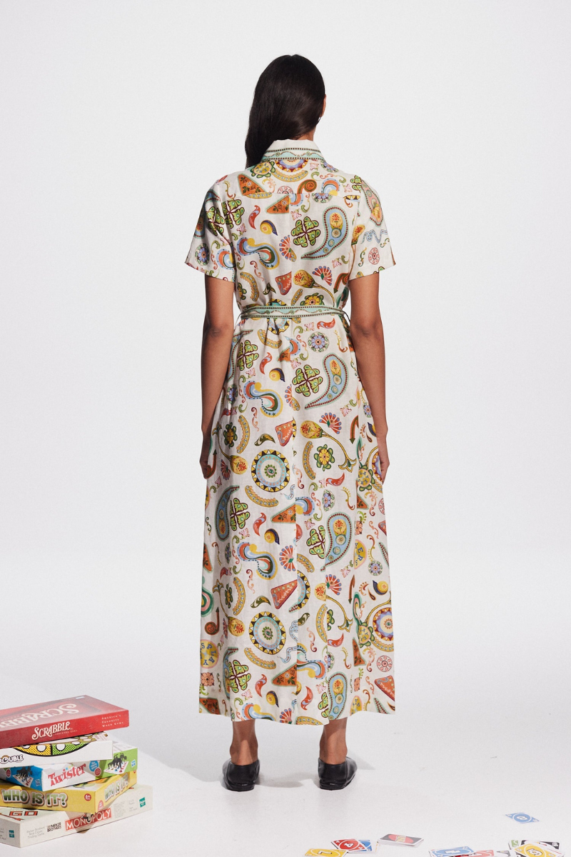 Woman in ivory paisley linen maxi dress with belt