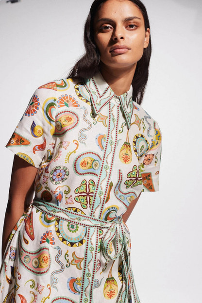 Woman in ivory paisley linen maxi dress with belt