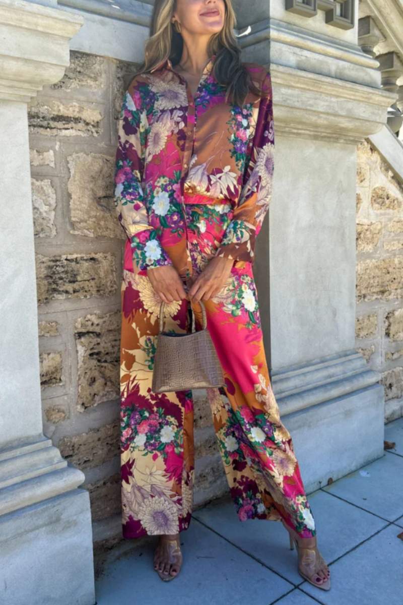 Woman in floral satin pantsuit standing on patio