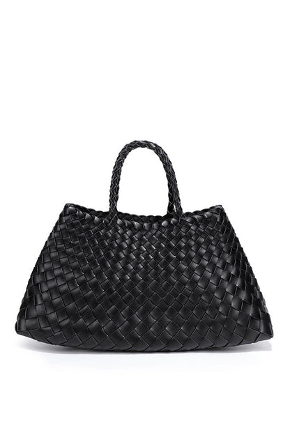 Woman holding brown woven tote bag