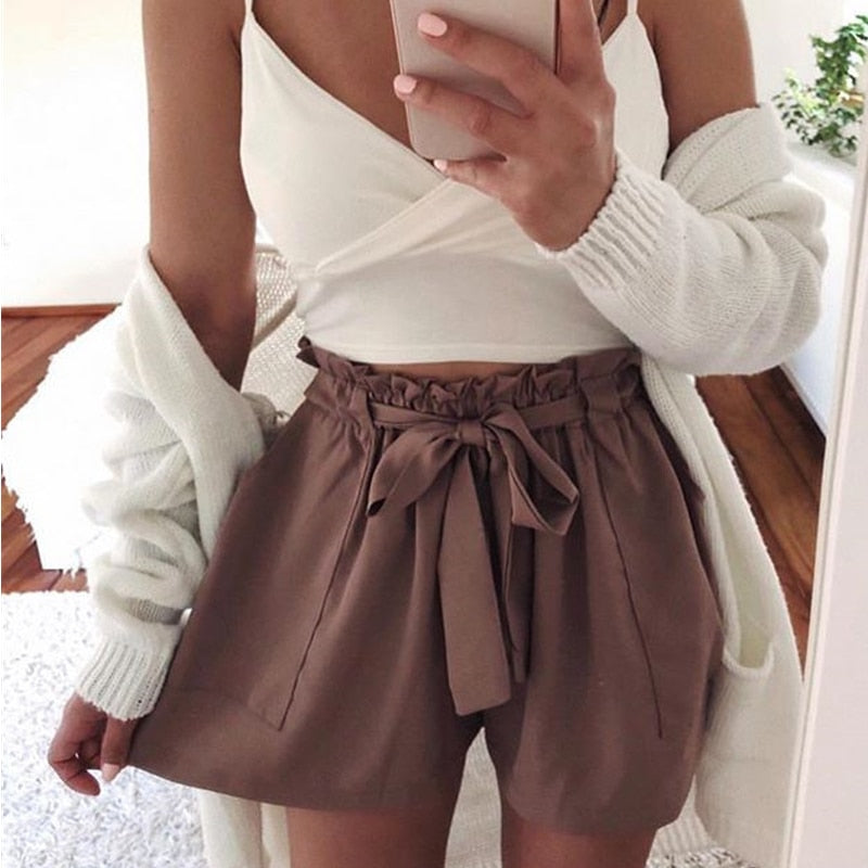 Woman wearing mocha brown paperbag waist shorts with tie.
